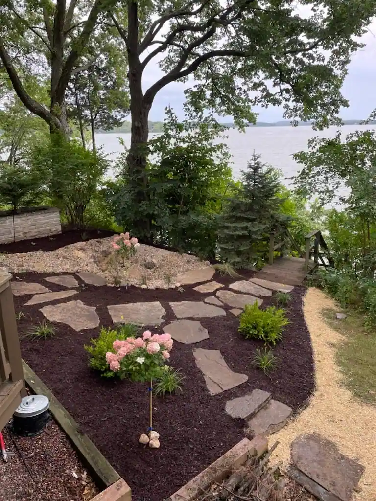 Lakefront landscape with stepping stones and fresh mulch beds